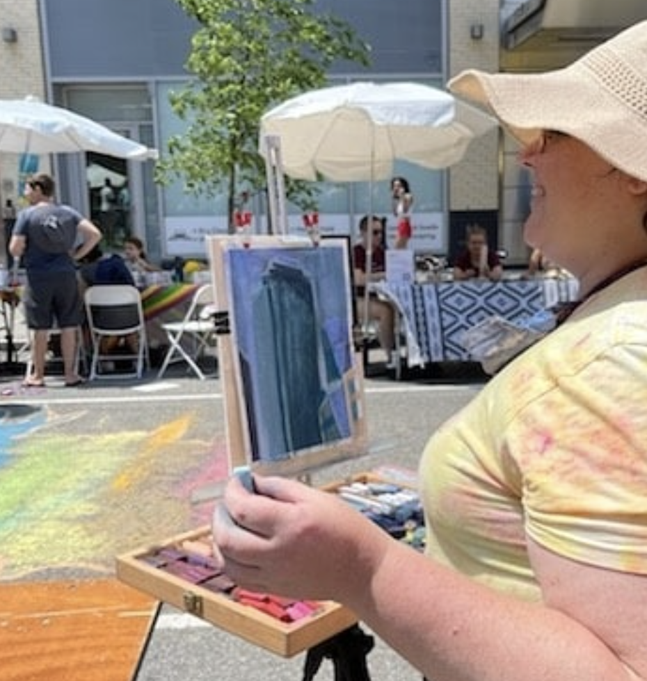 Artist painting at an outdoor art event
