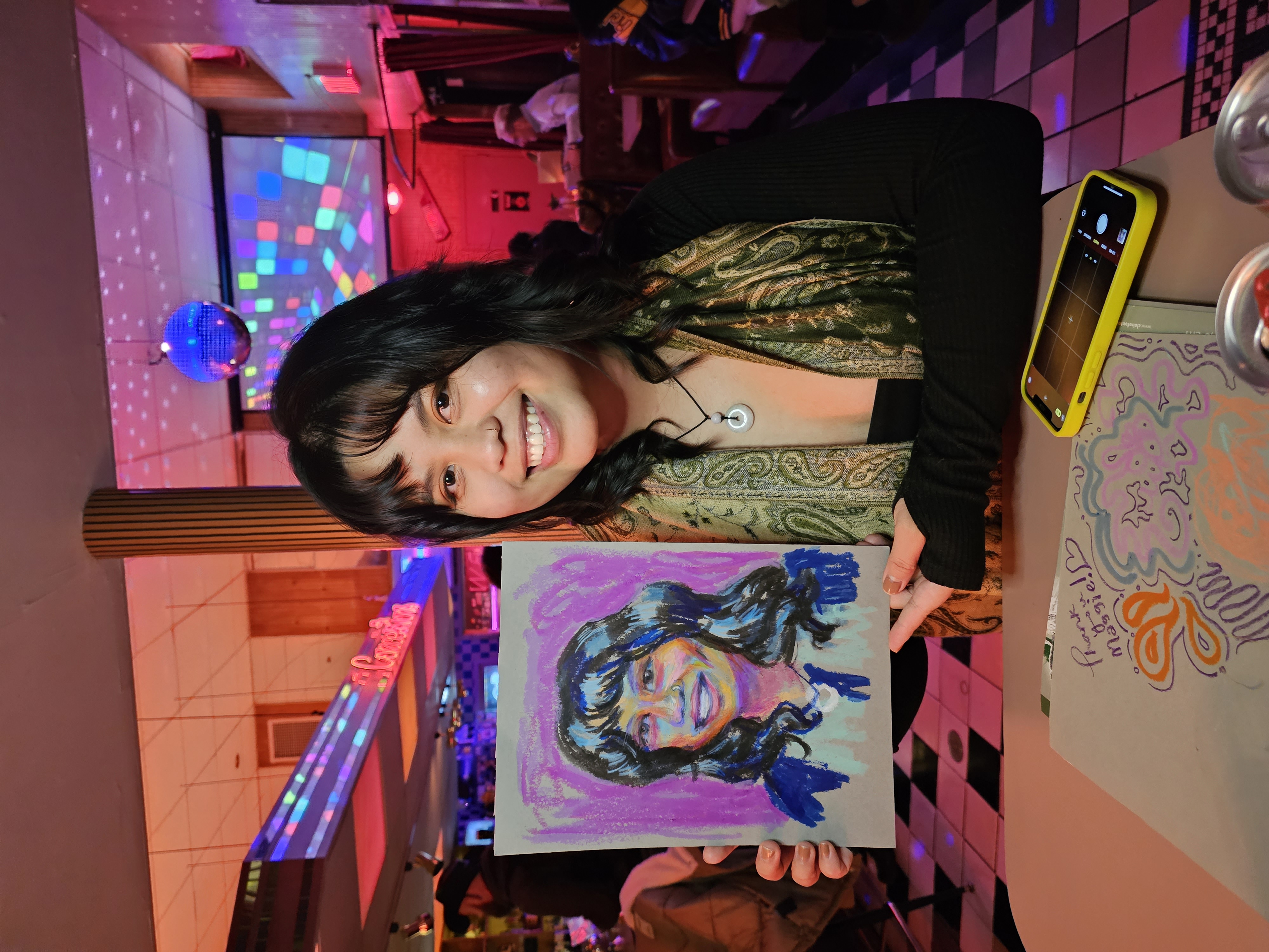 Guest holding her quick portrait painting